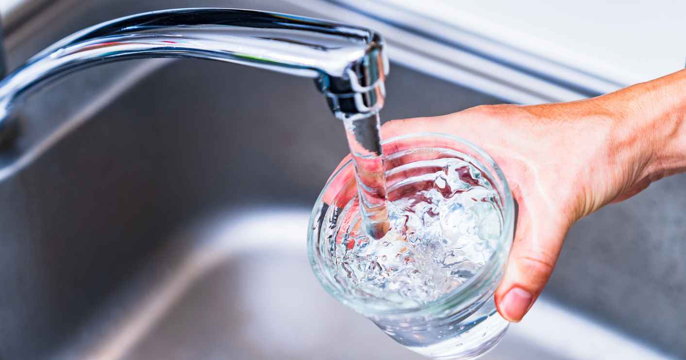 Filling up a glass of water in the sink